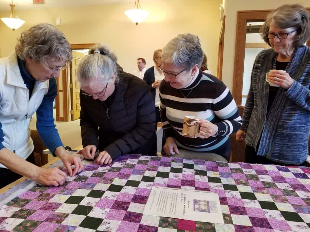 Women working a comforter blanker on February 2020 at Zion Mennonite Church, Broadway VA (Photo by Elwood Yoder)